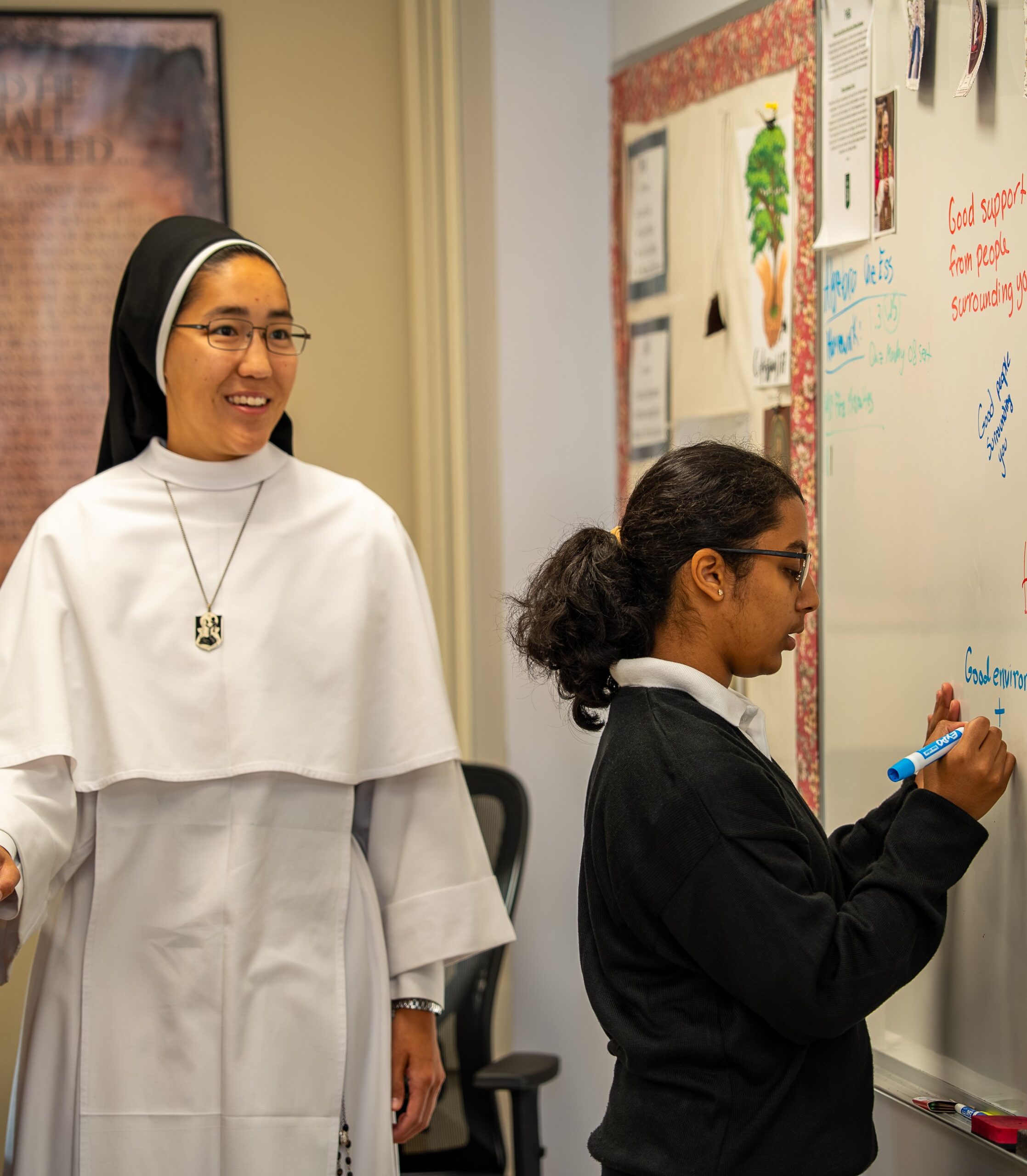 male student kneels before the altar